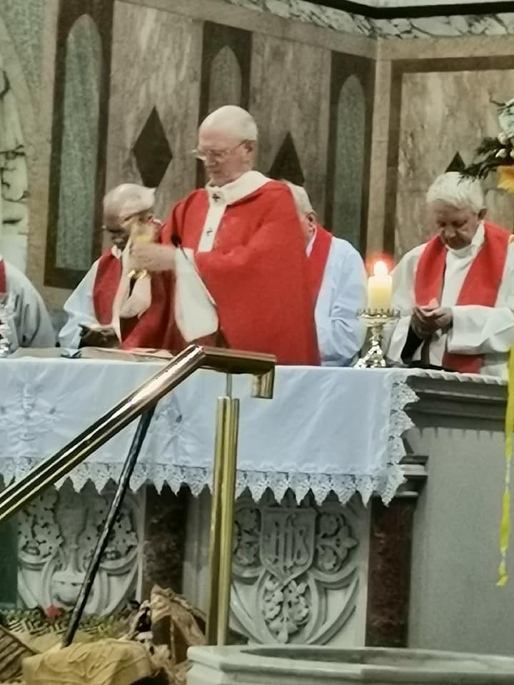 21 Archbishop Farrell raises the chalice